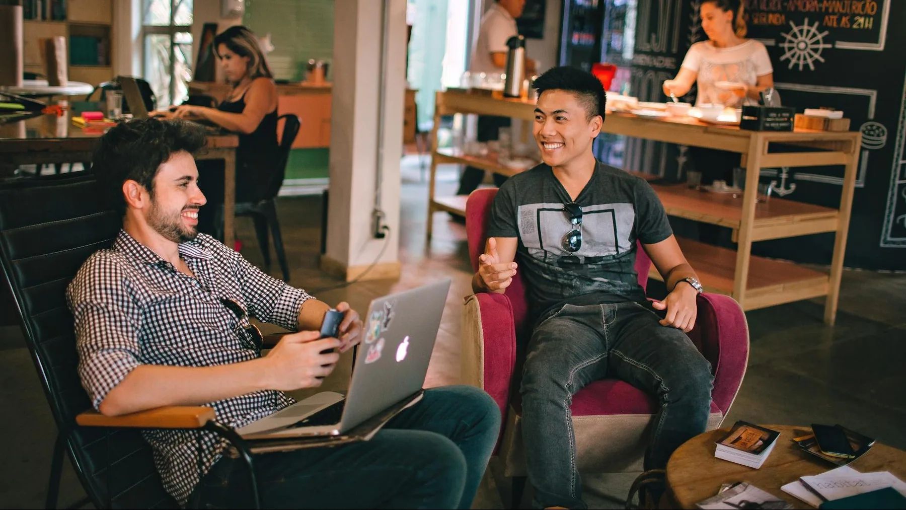 photograph of men having conversation seating on chair